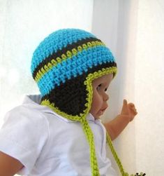 a small child wearing a crocheted hat