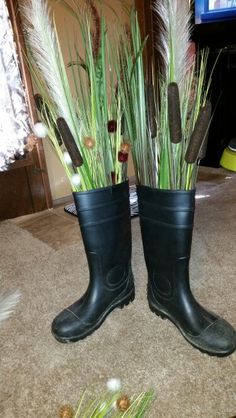 two black rubber boots with plants in them