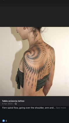 a woman with tattoos on her back and shoulder