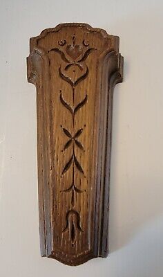 an old wooden wall hanging with carvings on it