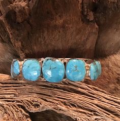 "Vintage Authentic Beautiful Navajo Zuni Sterling Silver Genuine 7 Stone Turquoise Hand Stamped Bracelet Cuff Very Sturdy Native American Navajo Zuni Tribe Sterling Silver Bracelet Cuff measuring 5/8 \" in width. The Cuff length is 5.5\" and 1 1/8 total 6 5/8\" and is Inlaid with 7 Beautiful genuine Sleeping Beauty turquoise stones. Absolutely Amazing.. and perfect for Native American jewelry collectors Sterling Silver Handcrafted by Navajo Artist Weighs 52g. Perfect for a Gift ❤️ Turquoise, or Western Style Blue Cuff Bangle Bracelet, Western Style Blue Bangle Jewelry, Southwestern Turquoise Bangle, Western Style Blue Cuff Bracelet Gift, Southwestern Style Blue Bangle Bracelets, Southwestern Style Blue Bangle Bracelet, Adjustable Southwestern Turquoise Cuff Bracelet, Adjustable Turquoise Southwestern Cuff Bracelet, Southwestern Style Turquoise Cuff Bracelet