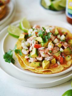 a white plate topped with food next to limes