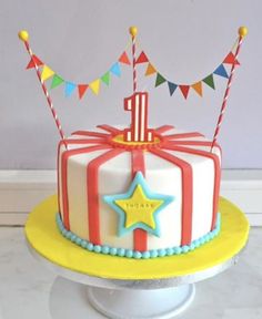 a birthday cake decorated with flags and stars on top of a table next to a cell phone