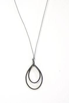 These simple yet striking metal pendant hangs from a long leather cord. Perfect for dressing up or down. Pendant is approximately 2" long by 1" wide. Hangs on a 32" leather cord. Available in bronze on a dark leather cord or black steel on a grey leather cord. Comes in a gift box. Treat yourself or a someone else! Handmade to order. Please allow 1-2 days for your necklace to ship. Long Leather Necklace, Ikea Hacks, Metal Pendant, Black Steel, Leather Necklace, Grey Leather, Leather Cord, Long Necklace, Silver Necklace