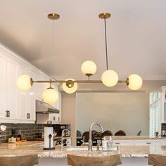 a kitchen with marble counter tops and wooden stools in front of the bar area