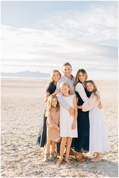 a family poses for a photo on the beach