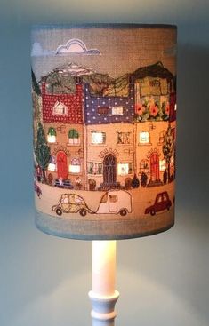 a lampshade with a city scene on it