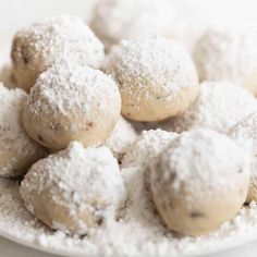 powdered sugar covered cookies on a white plate