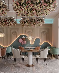 an elegant dining room with pink and white flowers hanging from the ceiling, along with pastel colored chairs