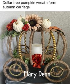 the pumpkin carriage is decorated with fall flowers and corn husks, as well as a candle