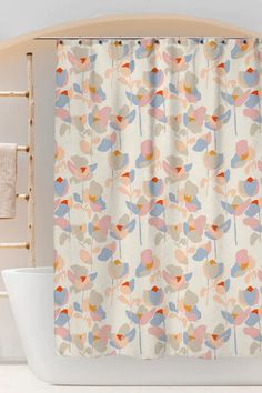 the shower curtain is decorated with colorful flowers