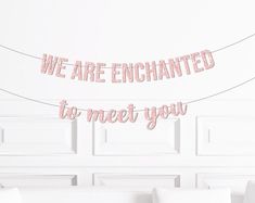 we are enchanted to meet you banner hanging on the wall above a bed