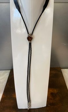 This genuine leather bolo tie features a 22 Carat Fire Agate set in a handmade sterling silver bezel setting. Also featured are handmade sterling silver tips in a western design. One of a kind, handmade by Barry Peterson Jewelers. Groomsmen Accessories, Silver Tips, Western Design, Fire Agate, Bolo Tie, Bridal Bands, Fine Jewelry Bracelets, Pendant Rings, Pearl Chain