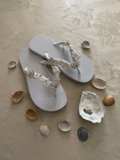 Beautiful BRIDAL Beach Sandals, exquisitely embellished with Bridal beaded lace,  amazing  glass crystals brooch on the center, and the flower glass crystals on the sides are 5/8'', glass round  pearls in varied sizes, Perfect for todays Brides EVERY SHOES ORDER IS HAND EMBELLISHED IN ORDER OF ARRIVAL THEREFORE,  SHOES CAN NOT BE RETURNED OR EXCHANGED; PLEASE CONFIRM YOUR SIZE FOR THESE SHOES WITH MEASURING FEET LENGHT GUIDE,PLEASE CONTACT ME FOR SIZE CHART OR ANY HELP.  I will try with the best of my abilities to help you have a very pleasant shopping experience. Please look at all the pictures These are  sandals with excellent workmanship and unique hand made embellishments. Whole sizes only COLORS: IVORY, OR WHITE 100% Vegan, no animal parts.  Place your order as soon as possible not RE Elegant Adjustable Flip Flops For Beach, Elegant Beaded Beach Sandals, Elegant Beaded Sandals For Beach, Elegant Silver Beach Flip Flops, White Beaded Sandals For Wedding, White Beaded Wedding Sandals, Elegant Rhinestone Flip Flops For Wedding, Elegant Wedding Flip Flops With Rhinestones, Elegant Rhinestone Wedding Flip Flops