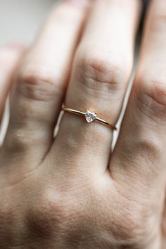 Introducing the newest addition to your stack! The Heart Diamond Stacker is sweet and playful with a dainty heart shaped diamond on a golden band. Wear your heart on your sleeve (or hand!) with this simple beauty. #ctwf Tiny Delicate Heart Promise Ring, Delicate Tiny Heart Promise Ring, Dainty Heart-shaped Rose Gold Diamond Ring, Delicate Heart Promise Ring, Dainty Rose Gold Heart-shaped Diamond Ring, Dainty Rose Gold Heart Diamond Ring, Heart-shaped Single Diamond Fine Jewelry Ring, Fine Jewelry Heart Ring With Single Round Cut Diamond, Minimalist Heart Shaped Stackable Promise Rings