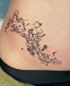 a woman's stomach with a tattoo design on it