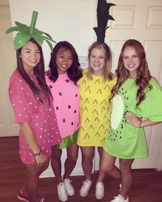 four girls dressed in costumes standing next to each other