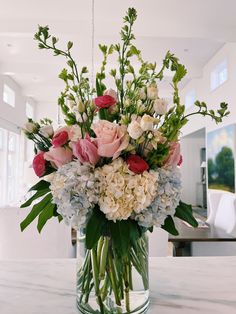 a vase filled with lots of pink and white flowers