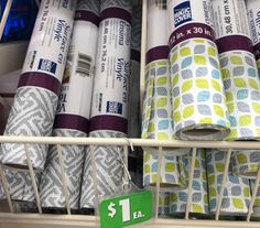 several rolls of toilet paper are on the shelf in a store with one dollar sign