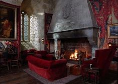 a living room filled with furniture and a fire place next to a painting on the wall