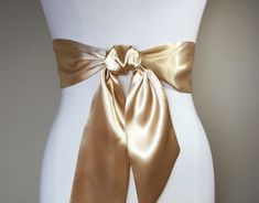 "Pale Gold Satin Sash, Light Gold Sash Belt Wide Gold Wedding Dress Sash Gold Bridal Sash Belt Pale Gold Bridesmaid Sash Satin Swank This Satin Swank® reversible waist sash is the perfect finishing touch for your bridesmaid, wedding, or special occasion dress, or just the right piece to add instant polish to your dress or top. Depending on your waist size and the length you choose (60, 75, and 90 inch lengths available), you can wrap the sash around your waist once or twice. You decide whether t Wedding Sashes With Satin Finish, Elegant Satin Sash With Tie Back, Wedding Satin Tie Back Sash, Fitted Bow Sash For Bridesmaid, Satin Sashes For Bridesmaids, Fitted Bridesmaid Sash With Bow, Elegant Fitted Tie Waist Sash, Elegant Fitted Tie-waist Sash, Tie Belts