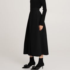 The black ankle-length Messina wool skirt is an elegant and classic piece of clothing. It is crafted from high-quality wool on a viscose lining. There are pleats at the front and back, which add volume and elegant shape to the skirt. Pockets in the side seams are a practical but discreet addition. Such a model combines classics with comfort and attention to detail, perfectly matching formal and casual styling. Main fabric: Wool 98%, Elastane 2% Lining: Viscose 100%    Dry cleaning only Polish Clothing, Animal Print Party, Knit Loungewear, Skirt Pockets, Fabric Wool, Stocking Fillers For Her, Holiday Party Outfit, Wool Skirt, Messina