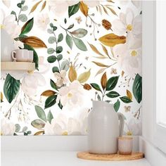 the wallpaper in this kitchen is painted with white flowers and green leaves