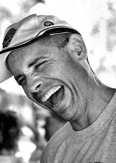 a black and white photo of a man laughing