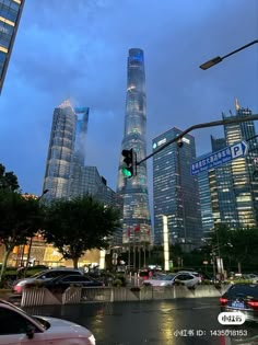 an intersection with traffic lights and skyscrapers in the background