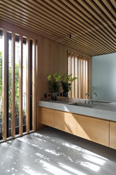 a bathroom with wood paneling and large windows