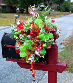 a mailbox decorated with green and red bows