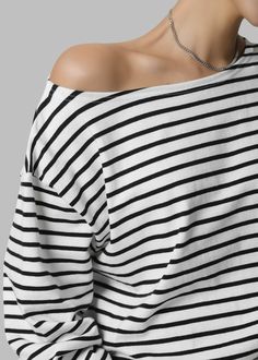 Color: Black Stripe Lightweight knit Relaxed fit Boat neck Drop shoulders Off the shoulder functionality Long sleeves Unlined 100% Cotton Machine Wash Cold By The Frankie Shop. Imported Chic Black Boat Neck Top, The Frankie Shop, Frankie Shop, Lightweight Knit, Boat Neck, Black Stripes, Drop Shoulder, Off The Shoulder, Stripes