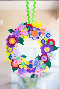 a paper flower wreath hanging from the ceiling