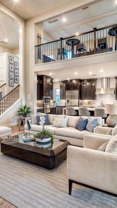 a living room filled with furniture next to a staircase