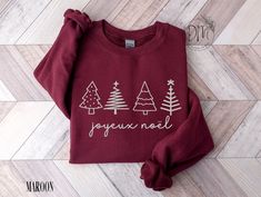 Celebrate the joy of the holiday season with our EMBROIDERED Joyeux Noël sweatshirt, a perfect blend of festivity and tradition. This French Christmas sweatshirt is a must-have for your holiday family gatherings, a cheerful way to spread the holiday spirit. ✨Please check the SIZE CHART image on the listing, and choose your size accordingly before placing your order. 🚫We do not accept exchanges, returns, or cancellations, however, if there are any quality issues with the item please contact us r Christmas Cricut Shirts, Xmas Sweatshirts, Womens Holiday Fashion, Christmas Tree Sweater, Tree Sweater, Merry Bright Christmas, Christmas Tree Shirt, Thoughtful Christmas Gifts, Winter Mode