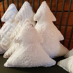 three white pillows sitting next to each other on a table