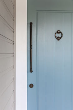 a blue front door with a metal handle