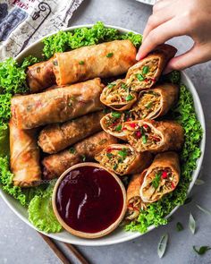 a plate filled with food and dipping sauce