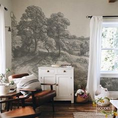 a living room with a couch, chair and painting on the wall