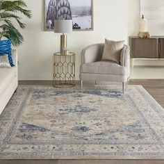 a living room with a couch, chair and rug in front of a painting on the wall