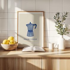 an open book sitting on top of a wooden table next to a bowl of lemons