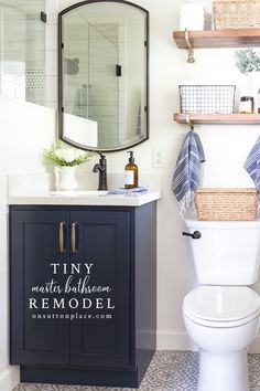 a white toilet sitting next to a sink in a bathroom under a mirror and shelves