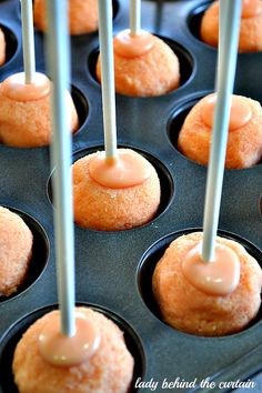 some cupcakes with icing on them in a muffin tin