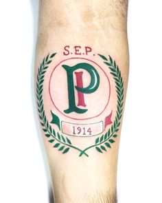 a man with a green and red tattoo on his leg that reads sep 1911