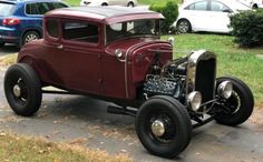 an antique car is parked on the side of the road