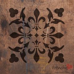 an old wooden wall with a stencil design on it