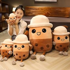 a woman sitting on the floor with some stuffed animals