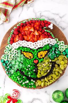 a cake decorated to look like a lepreite with strawberries and green beans