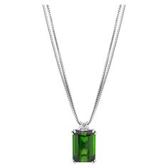 Gorgeous necklace, perfect for every day wear. Designed and created alongside matching earrings and ring that can be found in separate listings. Necklace Details: Emerald Cut Chrome Green Tourmaline (15.6 x 11.3 mm) weighing 11.58 Carats Very slightly bluish Green (vslbG) in color with dark tone and moderate saturation Trapezoid-shaped Diamond weighing 0.66 Carats Total Gem Weight: 12.24 Carats Overall Weight: 10 grams Finished Pendant Measurements: Length: 20.92 mm Width: 12.61 mm Double Box Ch Luxury Tourmaline Emerald Necklace, Formal White Gold Emerald Necklace, Green Emerald Necklace With Brilliant Cut For Formal Occasions, Green Fine Jewelry Necklace For Formal Occasions, Formal Gia Certified Emerald Necklace, Gia Certified Green Necklace For Formal Occasions, Formal Green Gia Certified Necklace, Green Emerald Diamond Cut Necklace For Formal Occasions, Green Emerald Necklace With Diamond Cut For Formal Occasions