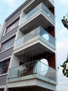 a tall building with lots of balconies on it's sides and windows